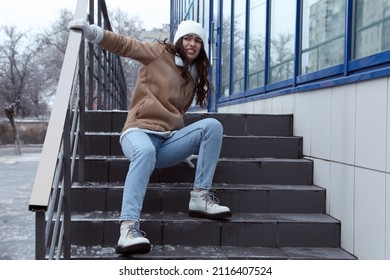 Young Woman Fallen On Slippery Stairs Covered With Ice Outdoors