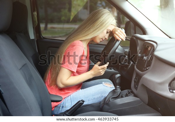 Young woman falling asleep in\
car