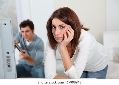 Young Woman Fed Up With Boyfriend Playing Video Game