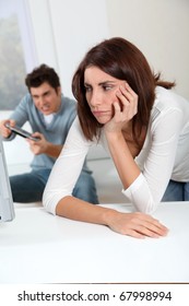 Young Woman Fed Up With Boyfriend Playing Video Game