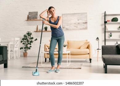 Young Woman Is Fed Up With Washing Floor In Cozy Living Room. Website Banner