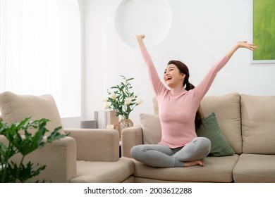 Young Woman Feel Carefree And Stretch Arm To Take A Deep Breath At Home