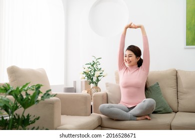 Young Woman Feel Carefree And Stretch Arm To Take A Deep Breath At Home