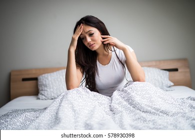 Young Woman Feel  Sick And Unwell On Bed