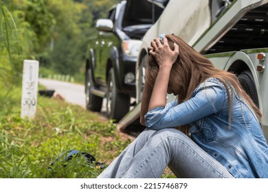 Young Woman Feeling Depressed When Car Having Problem On Mountain Road And Towing To Repair Shop By Towing Truck, Woman Driver Looks Sad With Car Accident On Road And Need Roadside Assistance To Help