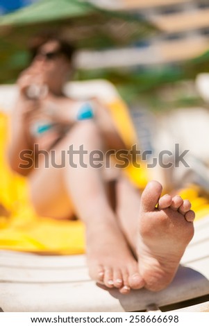 Young woman feet at the beach. Focus on feet