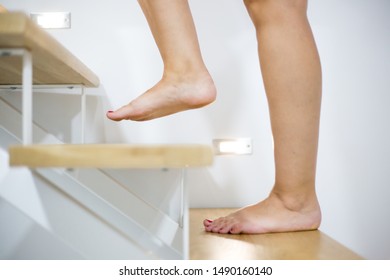 Young Woman Feets On The Wood Stairs