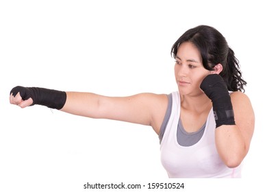 young woman in fighting stance on white background