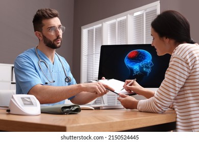 Young Woman Filling Form In Neurologist Office