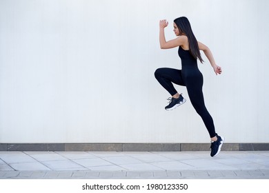 Young woman with fit body jumping and running