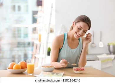 Young Woman In Fitness Clothes Having Healthy Breakfast At Home