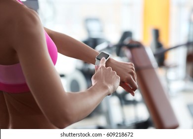 Young Woman With Fitness Tracker In Gym