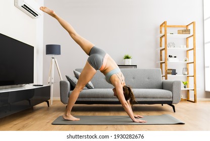 Young Woman In Fitness Wear Doing Exercise At Home