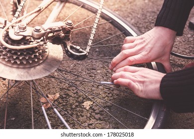 Young Woman Is Fixing Her Bike And Pumping Her Tires