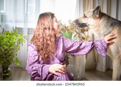 Young woman in a floral dress shares a tender moment with her German Shepherd dog indoors by a bright window - Powered by Shutterstock