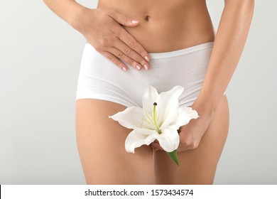 Young Woman With Flower On Grey Background. Gynecology Concept