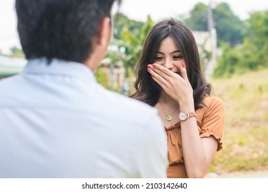 A young woman is flustered after a young man unexpectedly declares his love. Dating and courtship scene. - Shutterstock ID 2103142640