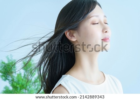 Young woman with fluttering hair and a smile