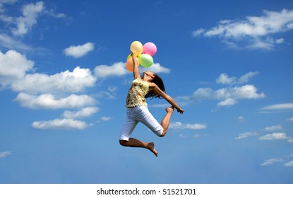 Young Woman Flying With Colorful Balloons
