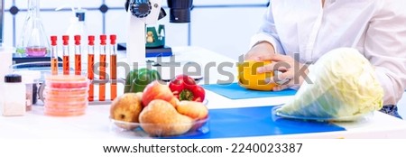 young woman in a food quality control laboratory examining samples of fruits and vegetables for toxins