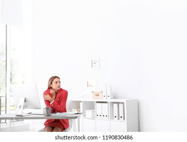 Young Woman Freezing Under Air Conditioner In Office