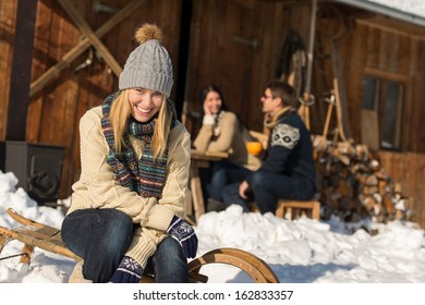 Young Woman With Friends Enjoy Weekend Break Snow Winter Cottage