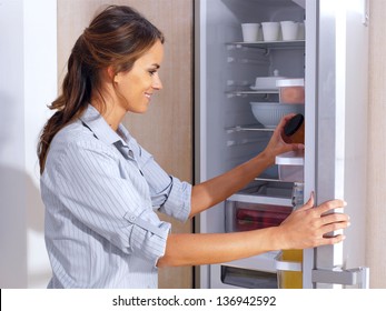 Young Woman In Front Of The Fridge