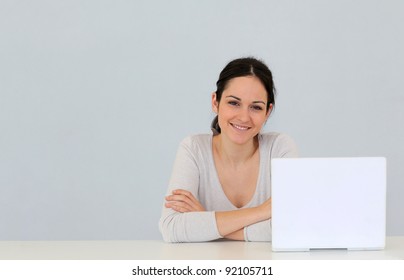 Young Woman In Front Of Laptop Computer Isolated