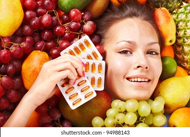 Young Woman With Fruit And Vitamin Pill. Isolated.