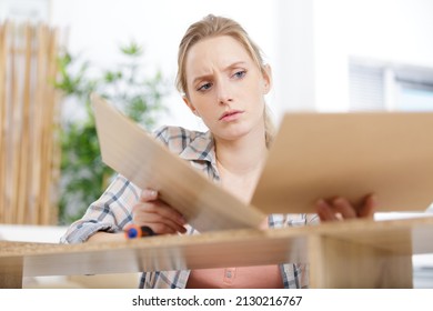 Young Woman Frustrated Fixing A Furniture