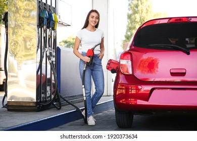 Young Woman With Fuel Pump Nozzle Near Car At Self Service Gas Station