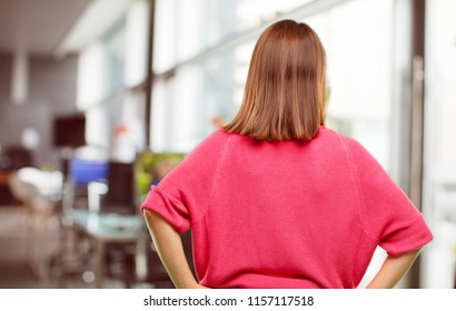 Young Woman Full Body. Back View, Both Hands On Hips With The Akimbo Pose, Probably Feeling Proud And Satisfied.