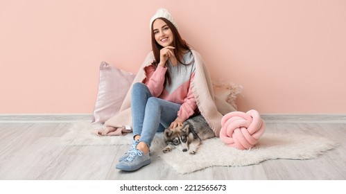 Young Woman With Funny Husky Puppy Sitting Near Pink Wall