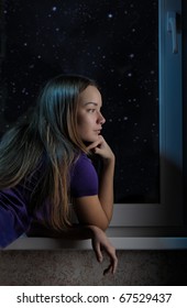 Young Woman Gazing Out A Window