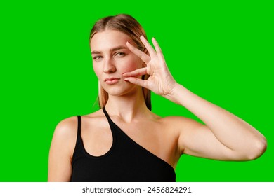 Young Woman Gesturing Silence With Finger on Lips Against Green Screen Background - Powered by Shutterstock