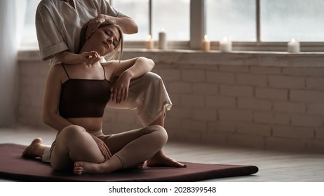               A young woman gets a Thai massage at a spa salon. Beige neutral colors. Copy space                       
