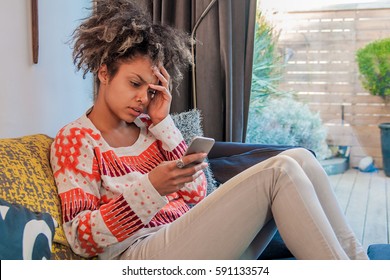 Young woman getting bad news by phone. unhappy woman talking on mobile phone looking down. Human face expression, emotion, bad news reaction