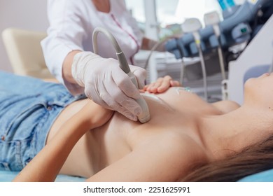 Young woman getting breast examination by her gynecologist ultrasound scanning