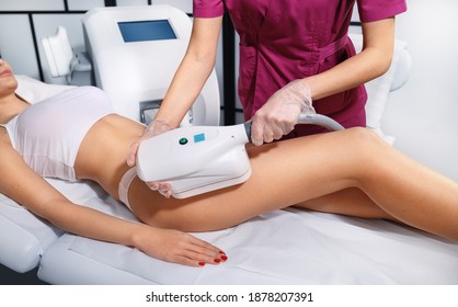 Young woman getting cryolipolyse treatment in cosmetic cabinet. Cool sculpting procedure for slimming thighs. Body Fat freezing technology - Shutterstock ID 1878207391