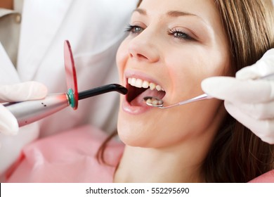 Young woman getting dental treatment. 