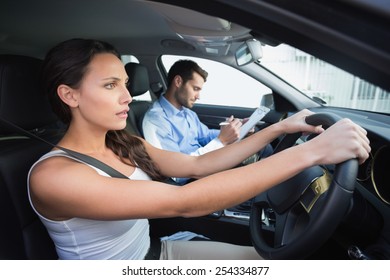 Young Woman Getting A Driving Lesson In The Car