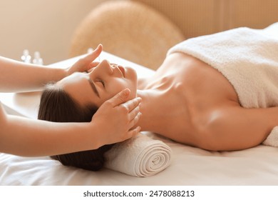 Young woman getting facial massage on couch in spa salon, closeup - Powered by Shutterstock