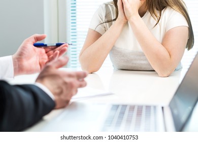 Young woman getting fired from work in office. Boss complaining or giving negative feedback to unhappy worker. Sad job applicant after failed interview. Business man telling bad news to employee.