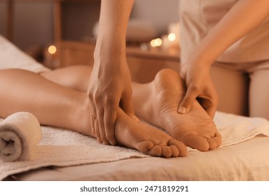 Young woman getting foot massage in dark spa salon, closeup - Powered by Shutterstock