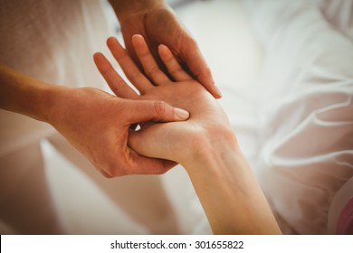 Young Woman Getting Hand Massage In Therapy Room