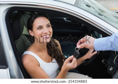 Young woman getting her key in the car