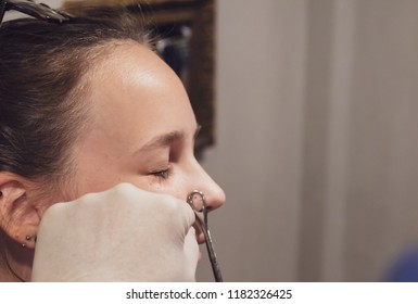 A Young Woman Getting Her Nose Pierced