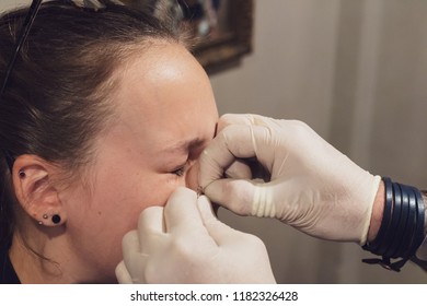 A Young Woman Getting Her Nose Pierced