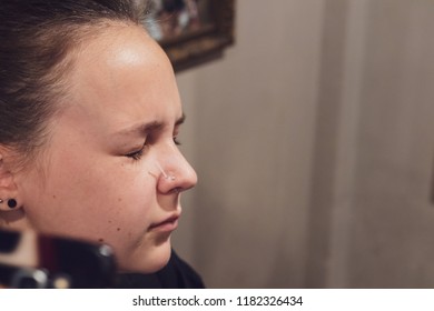 A Young Woman Getting Her Nose Pierced