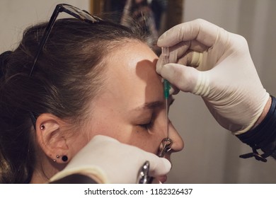 A Young Woman Getting Her Nose Pierced